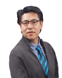 Wylie Eng wearing glasses, a dark suit, and a blue striped tie.