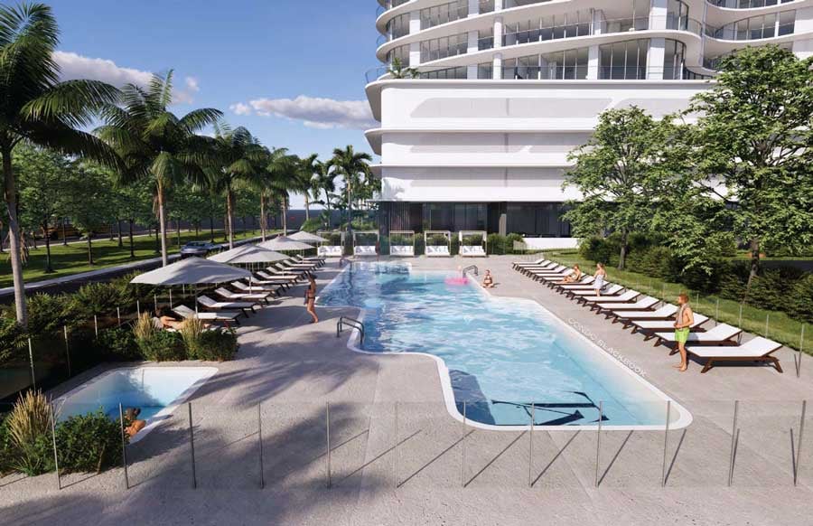 A curved modern condominium tower overlooks a resort-style pool with loungers and palms.