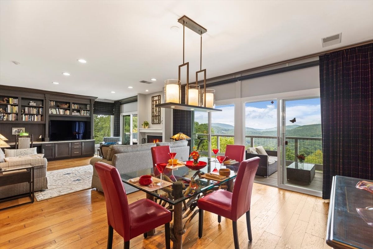 Dining and living room with mountain views at 104 VZ Top Road condo in Highlands NC