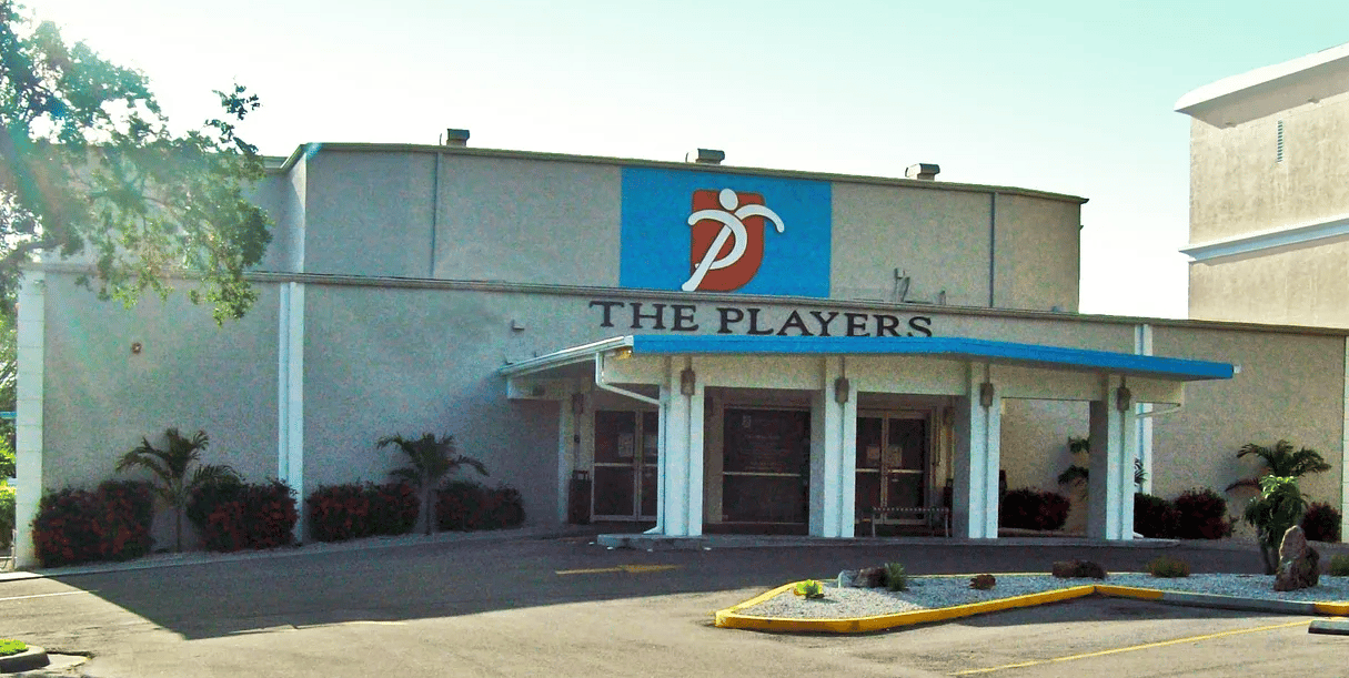 The Players theatre in Sarasota, with its blue awning and sign above the entrance.