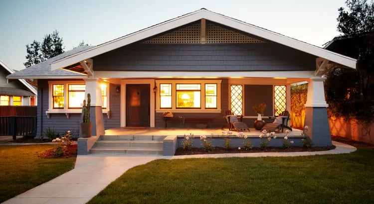 A well-lit and welcoming house with a front porch.