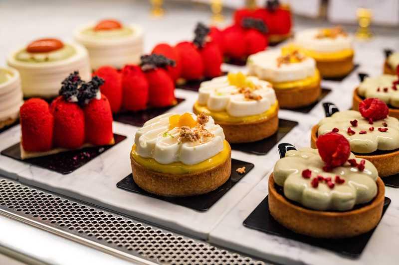 Assorted gourmet desserts overlooking the Tampa Bay waterfront at sunset, showcasing the best dessert destinations in Tampa and St. Petersburg, Florida.