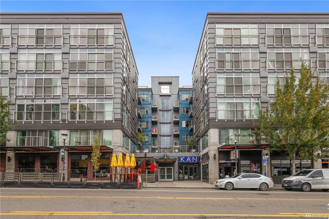 Stylish condominium facade with ground-floor retail, offering convenient and upscale urban living in the city.