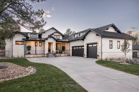 A stately custom home in Silverwood nestled under a dense canopy of mature oak trees with manicured lawns, showcasing the heritage luxury of Granite Bay, CA.