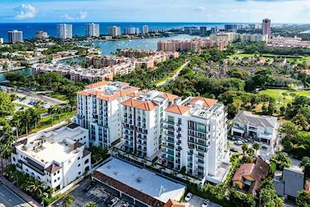 East Boca condos among green spaces, with the coastline and ocean in the distance.
