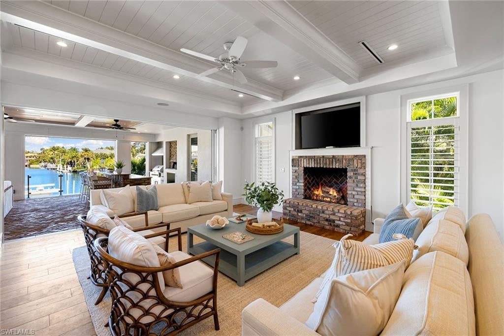 Luxury waterfront estate living room in Aqualane Shores Naples with open doors to canal and private boat dock