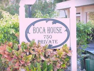 Boca House 750 Private entrance sign surrounded by tropical foliage.