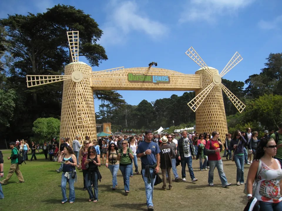 Vibrant crowd shot showing diverse festival-goers enjoying live music with the iconic Golden Gate Park trees in the background