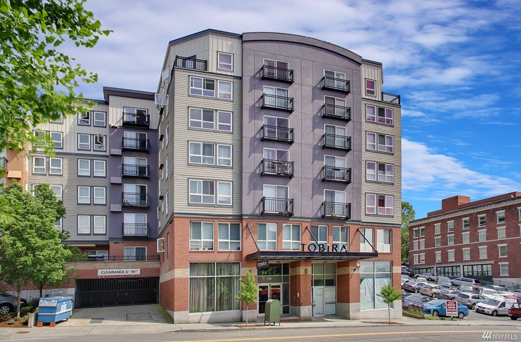 A stylish apartment building at the corner of a street.