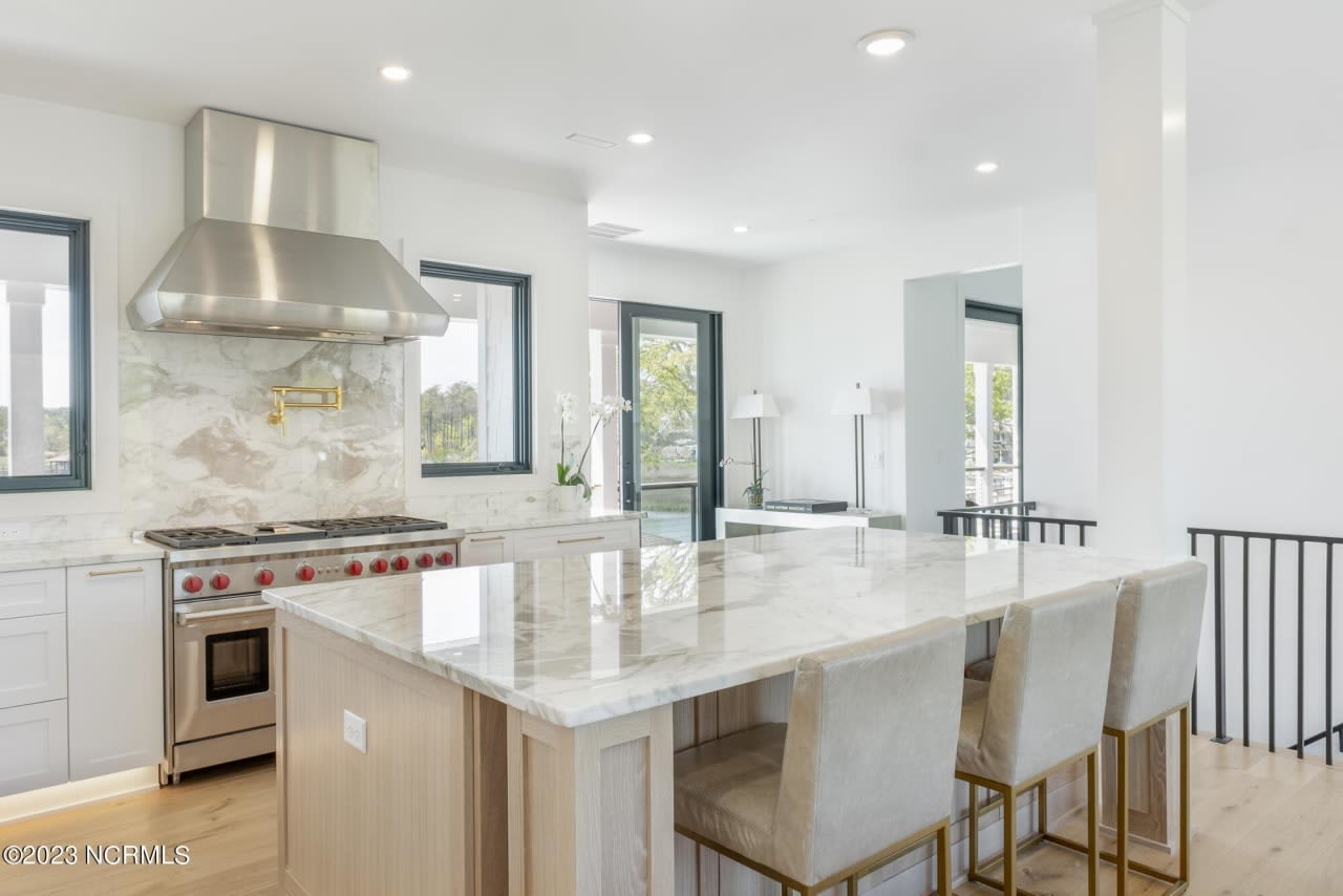 A gleaming kitchen in a luxury home featuring a sleek stove and spacious granite countertops.