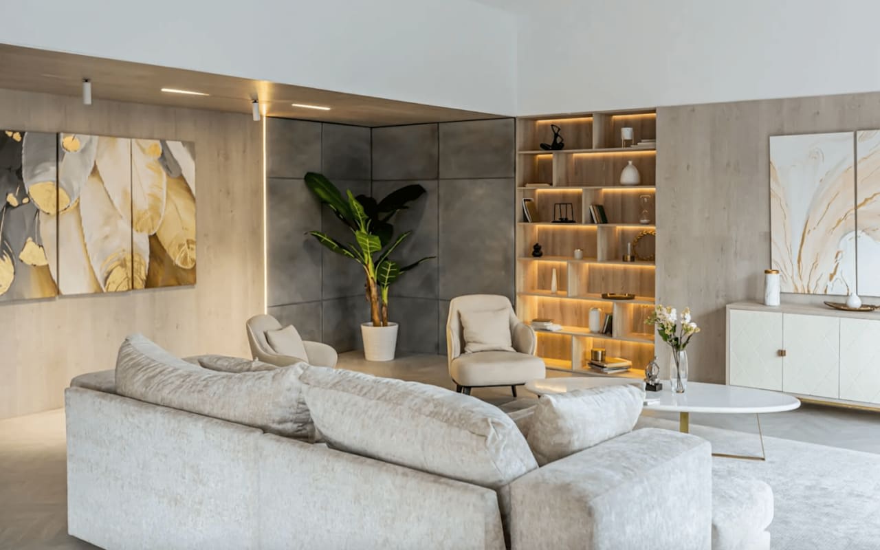 A modern and spacious living room with a neutral color palette of white, gray, and beige.