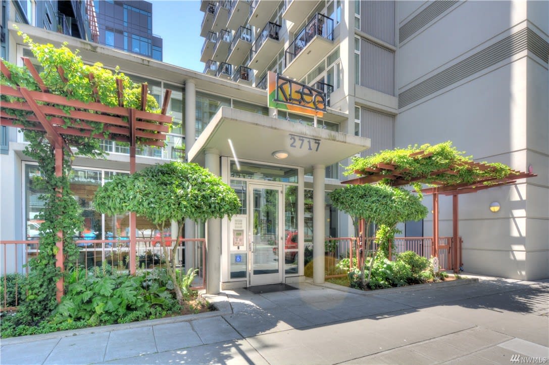 A building entrance embellished with thriving plants evokes a tranquil and welcoming mood.