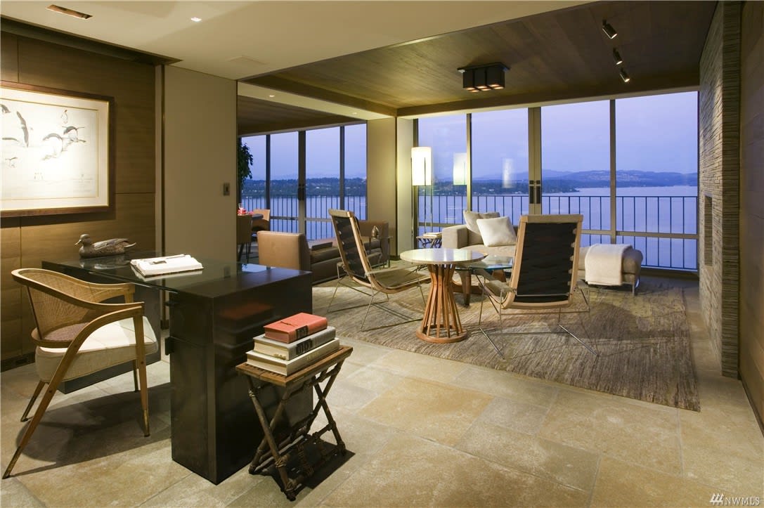 Elegant condo study with warm lighting and a view, exuding a sophisticated and tranquil ambiance.