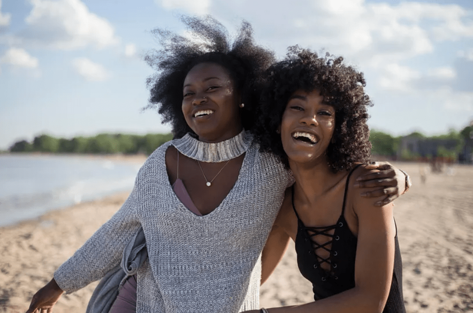 two women walking on the beach