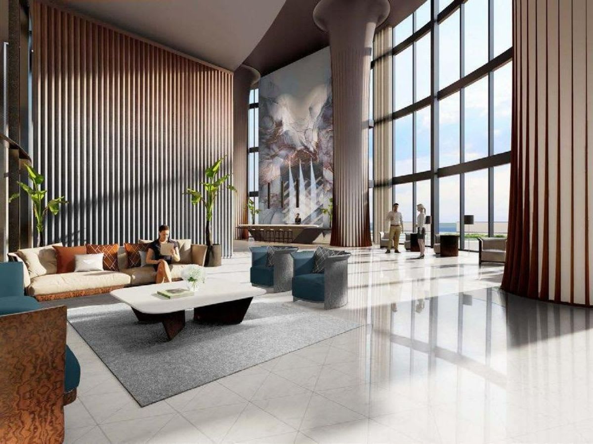 High-rise lobby lounge with floor-to-ceiling windows, sculptural columns, and ocean views.