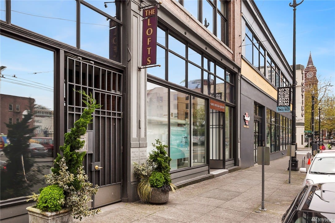 The street-level view of The Lofts showcases industrial-style luxury living in the city's heart.