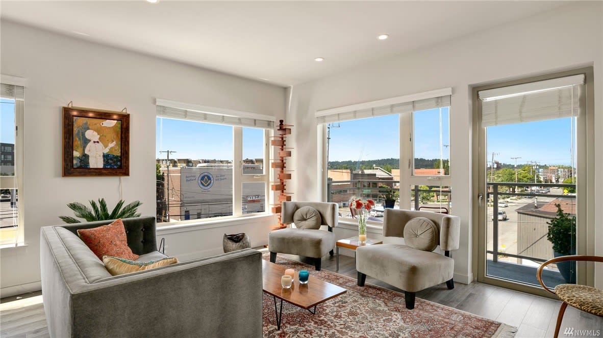 Inviting condo living room with plush seating and abundant natural light, offering a chic urban vibe.