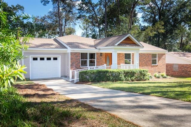 A charming single-story house in 1245 Winifred Dr with a brick and siding exterior. The property includes a driveway leading to a garage and a well-kept front yard with various plants.