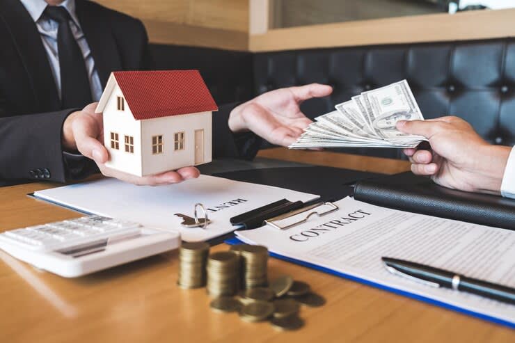 cropped hands buyer giving money to real estate agent