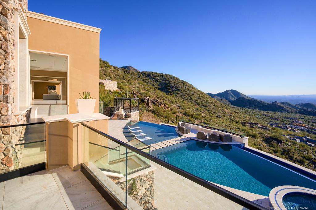 Infinity pool with stunning mountain views at a high-end hillside villa.