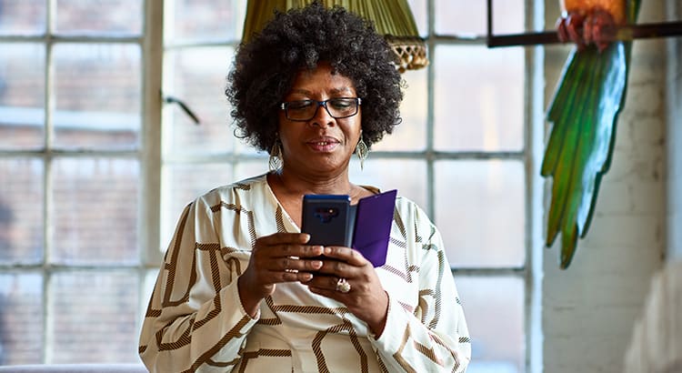 woman at home looking at phone