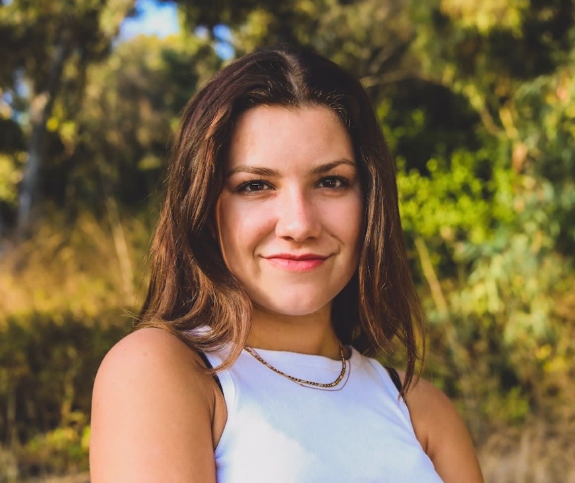 young woman with white tank top with green 