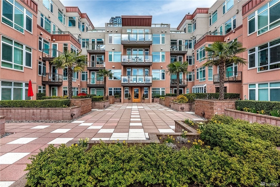 Sun-drenched modern condo with palm trees swaying.