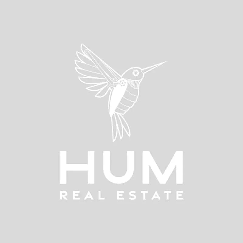 HUM Real Estate logo featuring a stylized hummingbird, against a gray background.