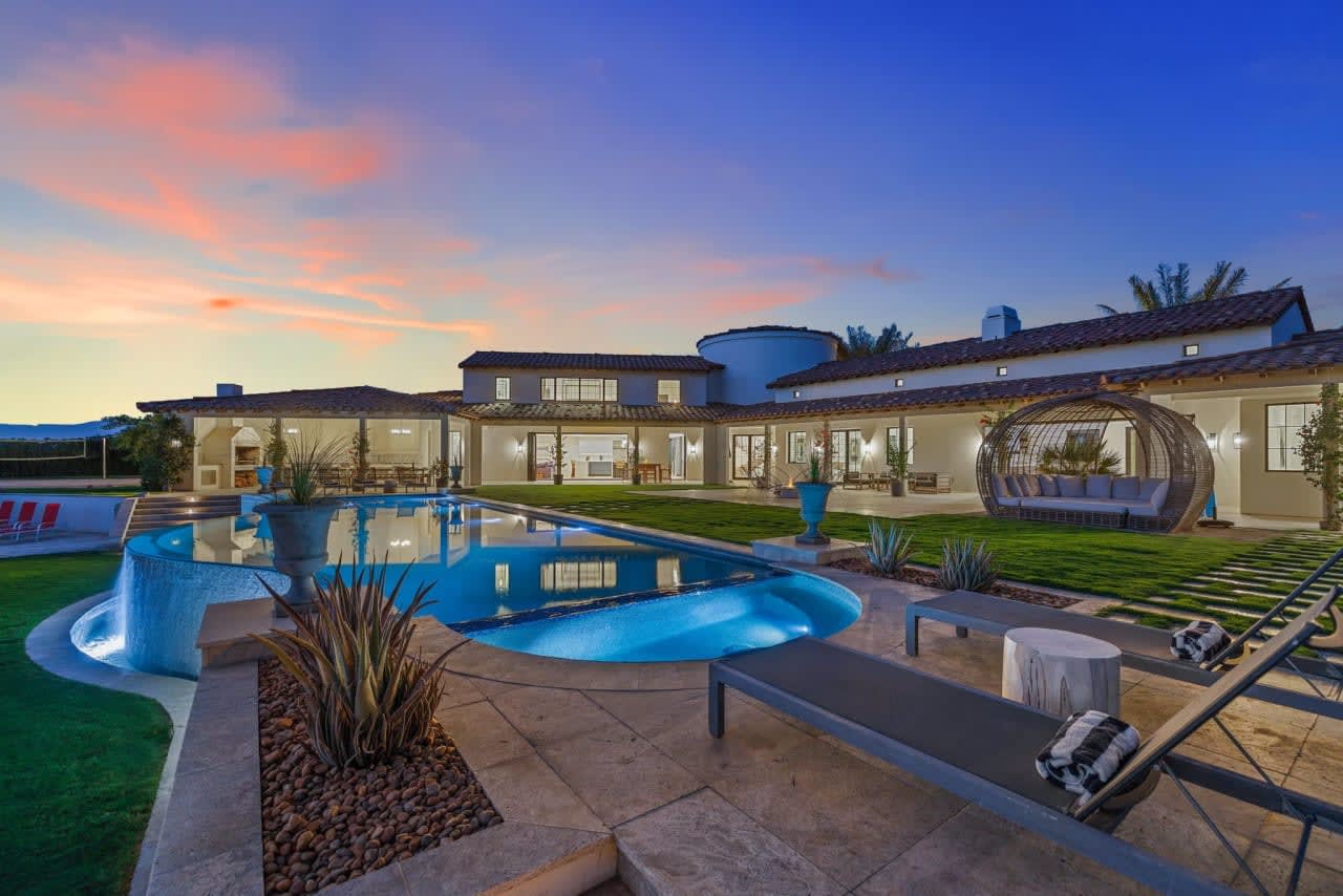 Spacious luxury home with pool and lawn in a serene setting. Imagine yourself living in this oasis of tranquility.