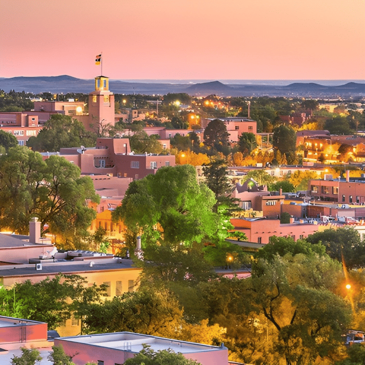 An aerial view of a city at dusk with a tower in the center.