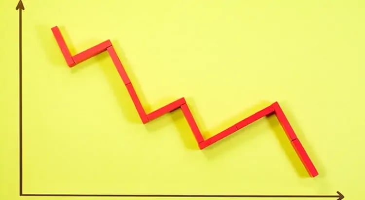 A red zigzag arrow on a bright yellow background, likely representing a financial or market trend, possibly a decline.