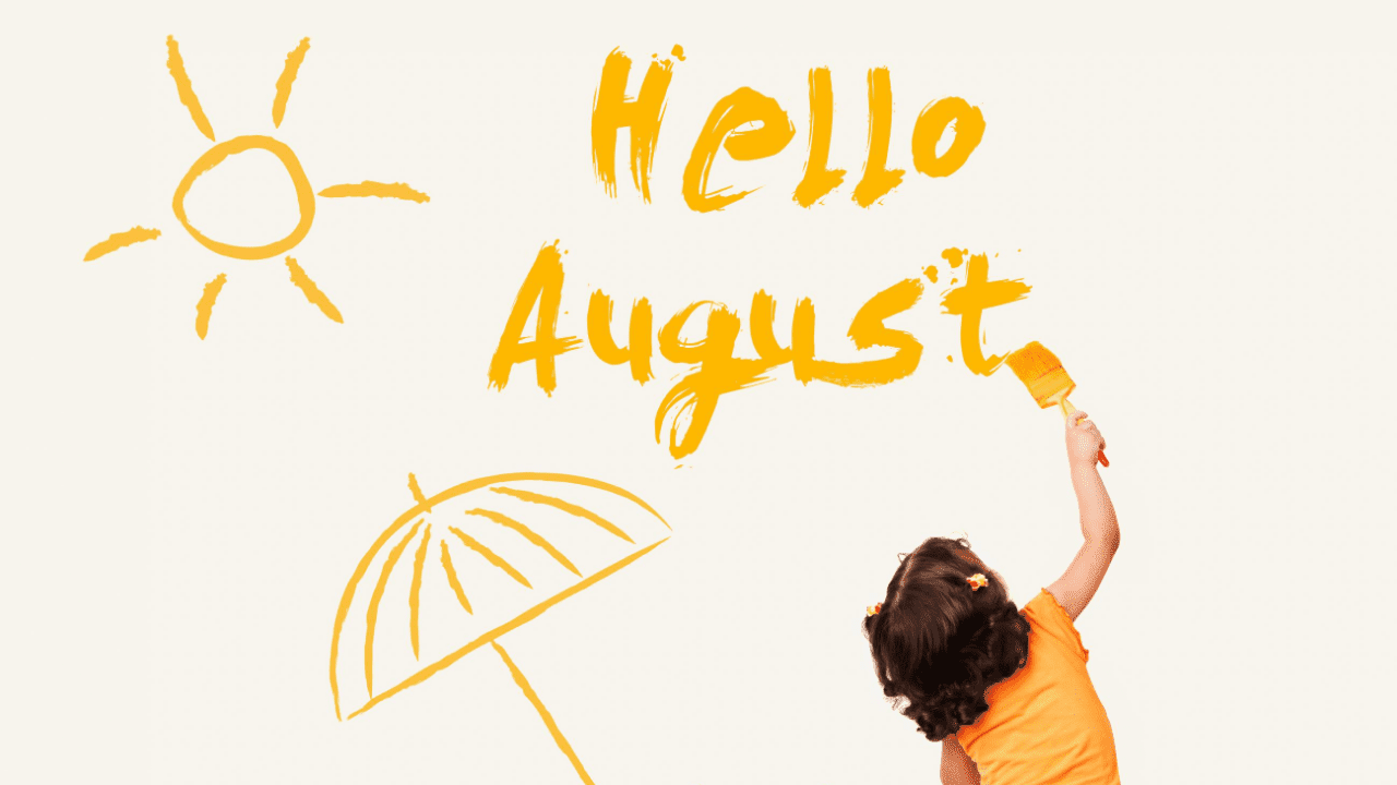 A young girl, seen from behind, is painting the words "Hello August" on a wall in bright orange paint. 