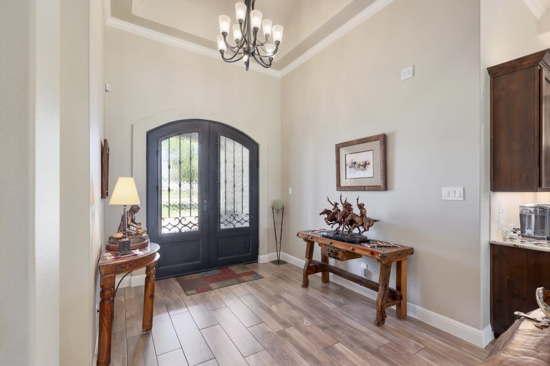 As you step inside, greeted by the grandeur of beautiful iron double doors you'll immediately feel welcomed by the inviting atmosphere of  this 4-bedroom, 3-bathroom home.