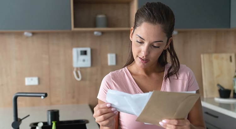 A woman reviewing a paper or document, possibly related to finances, real estate, or an important personal matter.