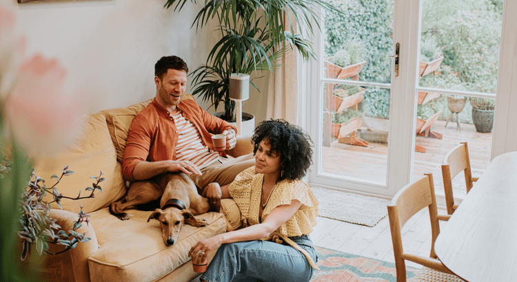 A photograph of a family sitting together with a dog, suggesting content related to the benefits of homeownership. 