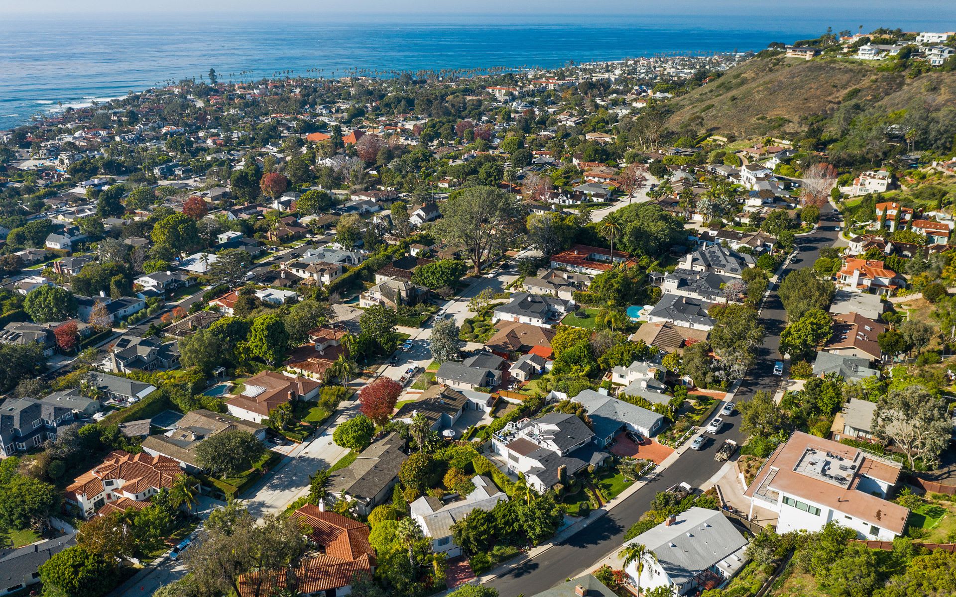 Upper Hermosa real estate: tree-lined residential streets in La Jolla with ocean views from the hills