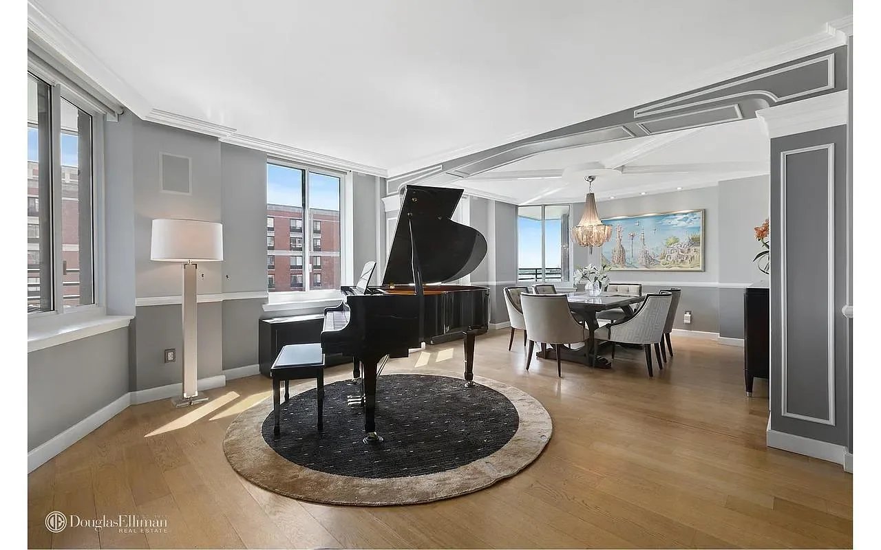 Furnished living and dining room with a black grand piano, tall windows, and hardwood floors.