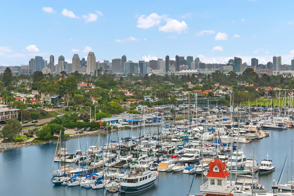 a harbor with boats docked in front of a city skyline