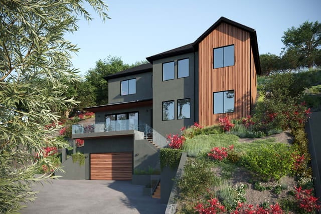 Modern home with a wood-clad gable, glass balcony, attached garage, and landscaped sloping grounds.