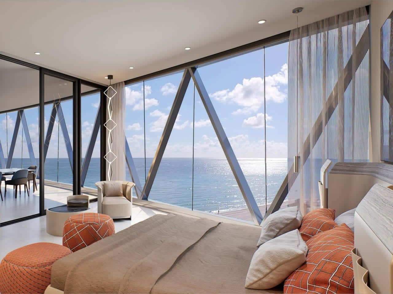 Staged bedroom with floor-to-ceiling windows overlooking the ocean.