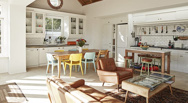 A modern kitchen and dining area with bright furniture.