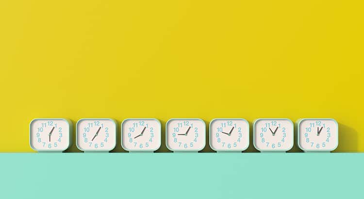 A row of clocks in a minimalist setting, potentially representing time management, scheduling, or deadlines.