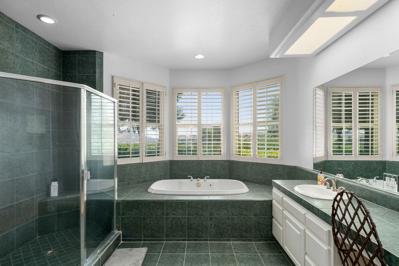 Bathroom with beautiful vineyard views at this Los Angeles winery property for sale.