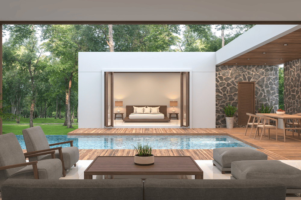 Modern home with a poolside deck, outdoor lounge, and open bedroom doors.