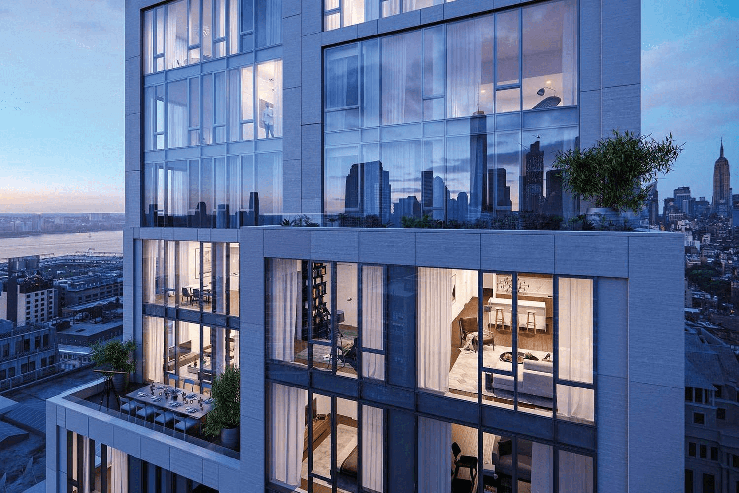 Modern glass residential tower at dusk, with illuminated apartments and Manhattan skyline views.