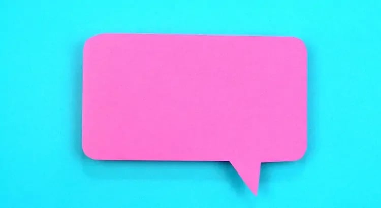 A bright pink speech bubble on a blue background, possibly used for a social media or communication-related theme.