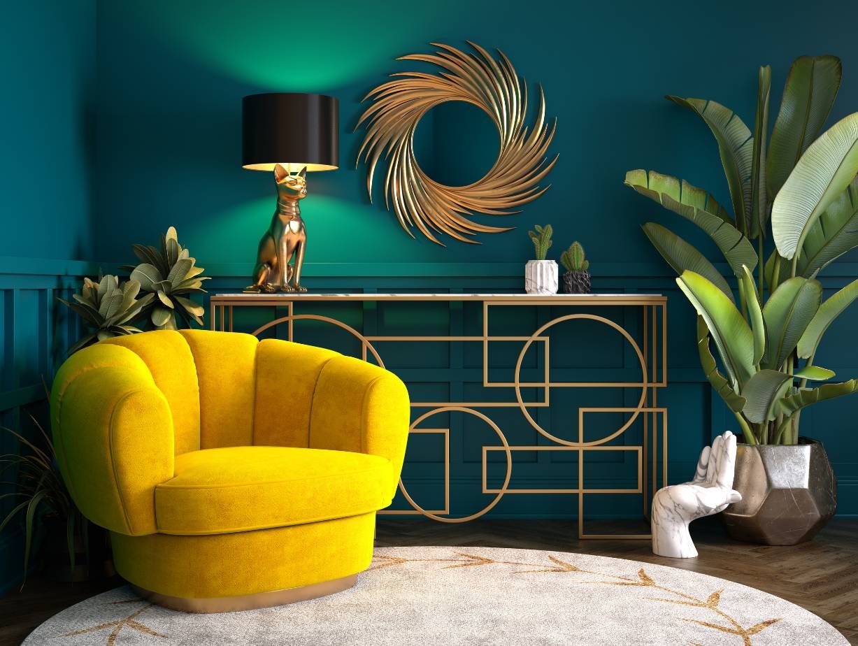 Living room with a mustard-yellow chair, teal paneled wall, gold accents, and leafy plants.