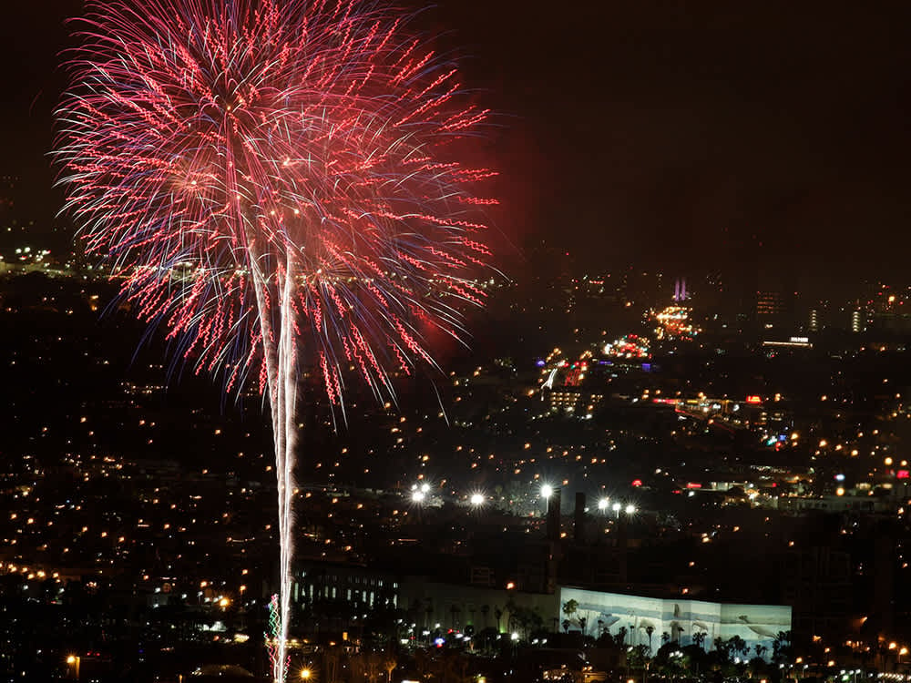 Large Red firework above cityscape at night