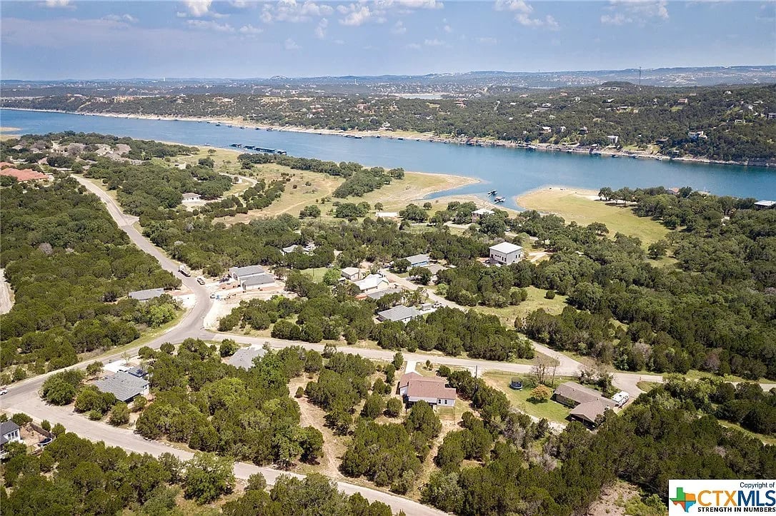 An aerial view of a city with a mix of residential and commercial buildings.