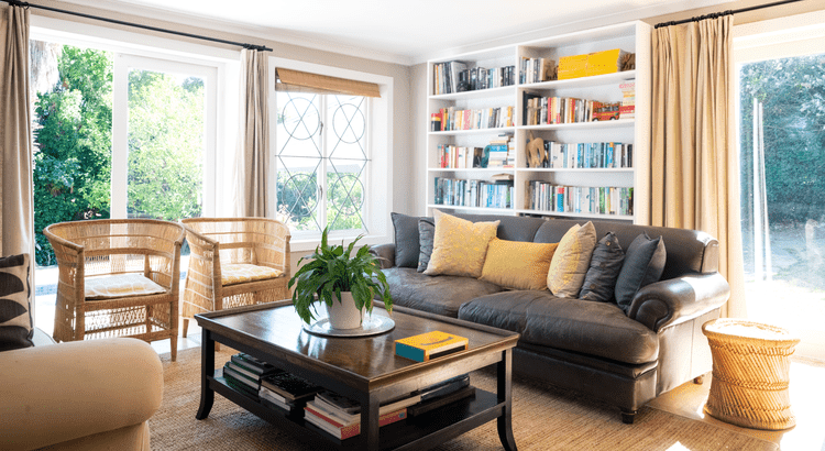 a living room with a black and beige wood theme and mirror doors